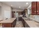 A spacious kitchen features stainless steel appliances and a large island with seating at 12325 W Berridge Ln, Litchfield Park, AZ 85340