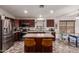 The kitchen features granite countertops, stainless steel appliances, and a center island at 12325 W Berridge Ln, Litchfield Park, AZ 85340