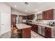 Kitchen featuring an island, stainless appliances, and tiled floors at 12325 W Berridge Ln, Litchfield Park, AZ 85340
