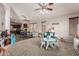 A large living room features carpet, a ceiling fan and lots of natural light at 12325 W Berridge Ln, Litchfield Park, AZ 85340