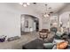 Open-concept living room, seamlessly connecting to other rooms, features neutral tones and plush carpet at 12325 W Berridge Ln, Litchfield Park, AZ 85340