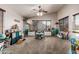 A large living room features carpet, a ceiling fan and lots of natural light at 12325 W Berridge Ln, Litchfield Park, AZ 85340