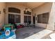 Covered outdoor patio with furniture and play area at 12325 W Berridge Ln, Litchfield Park, AZ 85340