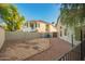 Backyard featuring dirt area, side of home, block fence, and view of another home at 1405 N Jamaica Way, Gilbert, AZ 85234