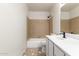 Bright bathroom with a single vanity, bathtub, and neutral tile flooring at 1405 N Jamaica Way, Gilbert, AZ 85234