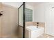 Bathroom with a tub, shower, and a unique glass block window at 1405 N Jamaica Way, Gilbert, AZ 85234