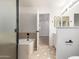 Bright bathroom with a tub, shower, and double sinks next to bedroom at 1405 N Jamaica Way, Gilbert, AZ 85234