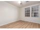Light-filled bedroom with wood-look flooring and two large windows at 1405 N Jamaica Way, Gilbert, AZ 85234