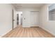 Spacious bedroom with wood-look floors, closet, and open doorway at 1405 N Jamaica Way, Gilbert, AZ 85234
