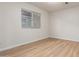 Well-lit bedroom with wood-look floors and a view of a neighboring property at 1405 N Jamaica Way, Gilbert, AZ 85234