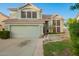 This two-story home features a tile roof, a well-manicured lawn, and large windows at 1405 N Jamaica Way, Gilbert, AZ 85234