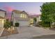 Charming two-story home boasts a tile roof, a spacious two-car garage and a well-maintained landscaped yard at 1405 N Jamaica Way, Gilbert, AZ 85234