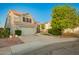 Charming two-story home boasts a tile roof, a spacious two-car garage and a well-maintained landscaped yard at 1405 N Jamaica Way, Gilbert, AZ 85234