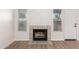 Living room fireplace with tile surround and two windows at 1405 N Jamaica Way, Gilbert, AZ 85234