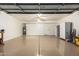 Spacious garage with epoxy flooring, storage cabinets, and a ceiling fan at 1405 N Jamaica Way, Gilbert, AZ 85234