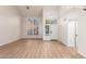 Bright living room with wood floors, high ceilings, and lots of natural light from multiple windows at 1405 N Jamaica Way, Gilbert, AZ 85234