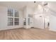 Bright living room with wood floors, high ceilings, and lots of natural light from multiple windows at 1405 N Jamaica Way, Gilbert, AZ 85234
