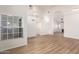 Bright living room with wood floors, high ceilings, and lots of natural light from multiple windows at 1405 N Jamaica Way, Gilbert, AZ 85234