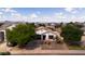 An aerial shot of a suburban neighborhood showcasing a well-maintained, single-story home with desert landscaping at 1432 E Penny Ln, San Tan Valley, AZ 85140