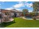 Well-maintained backyard featuring a private pool, lounge chairs, outdoor kitchen, and covered patio space at 1432 E Penny Ln, San Tan Valley, AZ 85140