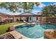 Inviting backyard featuring a private pool, tanning ledge, lounge seating, and covered patio, perfect for relaxation at 1432 E Penny Ln, San Tan Valley, AZ 85140