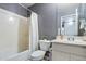 Cozy bathroom with a tub and shower, and a white vanity, offering a space for relaxation at 1432 E Penny Ln, San Tan Valley, AZ 85140