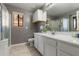 Bathroom with double sink vanity, white cabinets, and a shower-tub combination behind a glass door at 1432 E Penny Ln, San Tan Valley, AZ 85140