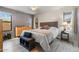 Comfortable bedroom featuring natural light, complemented by an accent wall, dresser, and bedside table at 1432 E Penny Ln, San Tan Valley, AZ 85140