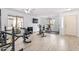 Bright home gym featuring ample natural light, light wood floors and a variety of exercise equipment at 1432 E Penny Ln, San Tan Valley, AZ 85140