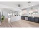 Bright, open-concept kitchen featuring two-tone cabinets, sleek appliances, and light wood flooring at 1432 E Penny Ln, San Tan Valley, AZ 85140