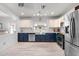 Modern kitchen featuring two-tone cabinets, stainless steel appliances, and a large farmhouse sink at 1432 E Penny Ln, San Tan Valley, AZ 85140