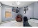 Functional home office with a comfortable armchair and desk area, ideal for work and study at 1432 E Penny Ln, San Tan Valley, AZ 85140