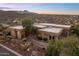 Aerial view of a sprawling desert home with landscaped grounds and mountain views at 15054 E Sundown Dr, Fountain Hills, AZ 85268