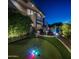 Backyard oasis with a putting green, pool, spa, and lush landscaping at 15054 E Sundown Dr, Fountain Hills, AZ 85268