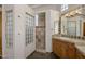Bathroom featuring glass block details, walk-in shower, and wooden cabinetry at 15054 E Sundown Dr, Fountain Hills, AZ 85268
