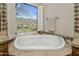 Bathroom highlighting a soaking tub and serene outdoor views at 15054 E Sundown Dr, Fountain Hills, AZ 85268