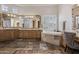 Bathroom featuring dual vanities, a soaking tub, and elegant tile work at 15054 E Sundown Dr, Fountain Hills, AZ 85268