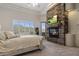 Spacious bedroom with a stone fireplace, television, and neutral decor at 15054 E Sundown Dr, Fountain Hills, AZ 85268