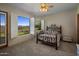 Comfortable bedroom with a ceiling fan, neutral walls, and views of the manicured lawn, patio and mountains at 15054 E Sundown Dr, Fountain Hills, AZ 85268