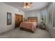 A cozy bedroom with neutral decor, a ceiling fan, a closet, and a shuttered window at 15054 E Sundown Dr, Fountain Hills, AZ 85268
