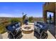 Outdoor fire pit with comfortable seating offering panoramic views of the surrounding landscape and a spa at 15054 E Sundown Dr, Fountain Hills, AZ 85268