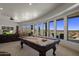 This entertainment room offers a billiard table, scenic views, and comfortable seating at 15054 E Sundown Dr, Fountain Hills, AZ 85268