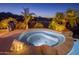 Relaxing hot tub with candles and wine, offering panoramic city and mountain views at night at 15054 E Sundown Dr, Fountain Hills, AZ 85268