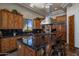 Spacious kitchen with black countertops, wood cabinets, stainless steel appliances and island with seating at 15054 E Sundown Dr, Fountain Hills, AZ 85268
