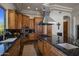 Modern kitchen featuring granite countertops, wood cabinets, and stainless steel appliances at 15054 E Sundown Dr, Fountain Hills, AZ 85268