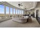 Bright living room featuring large windows with mountain views and neutral toned curved sofa at 15054 E Sundown Dr, Fountain Hills, AZ 85268