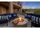 Cozy patio featuring a stone support column, gas firepit, comfortable lounge seating and views of a beautiful sunset at 15054 E Sundown Dr, Fountain Hills, AZ 85268