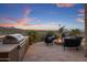 Outdoor patio featuring a built-in barbeque, comfortable seating, a gas fire pit and mountain views at 15054 E Sundown Dr, Fountain Hills, AZ 85268