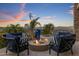 Outdoor patio area features a gas firepit, mountain views, a large decorative vase and comfortable seating at 15054 E Sundown Dr, Fountain Hills, AZ 85268
