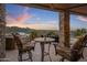 Covered outdoor patio with a built-in grill, comfortable seating, beautiful views and a stone support column at 15054 E Sundown Dr, Fountain Hills, AZ 85268